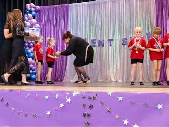 performers walking on stage to receive awards