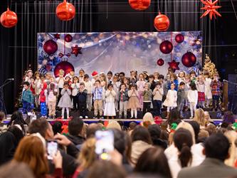wide angle of students on stage in front of crowd