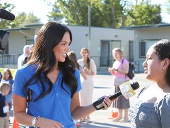 news team speaking with students