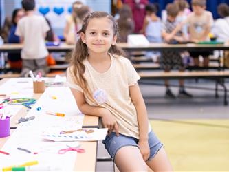 student posing at table 