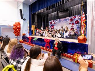 wide angle of students on stage in front of crowd