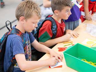 students at table with crafts