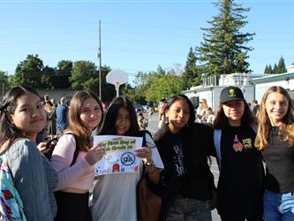 students holding first day of school sign