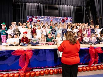 students excitedly performing for event