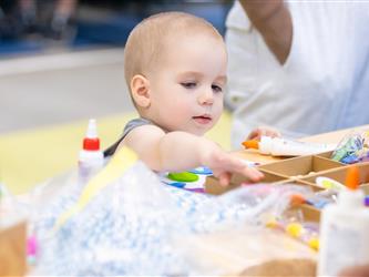 baby reaching for crafts