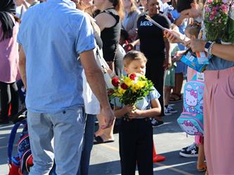 student holding bouquet of flowers